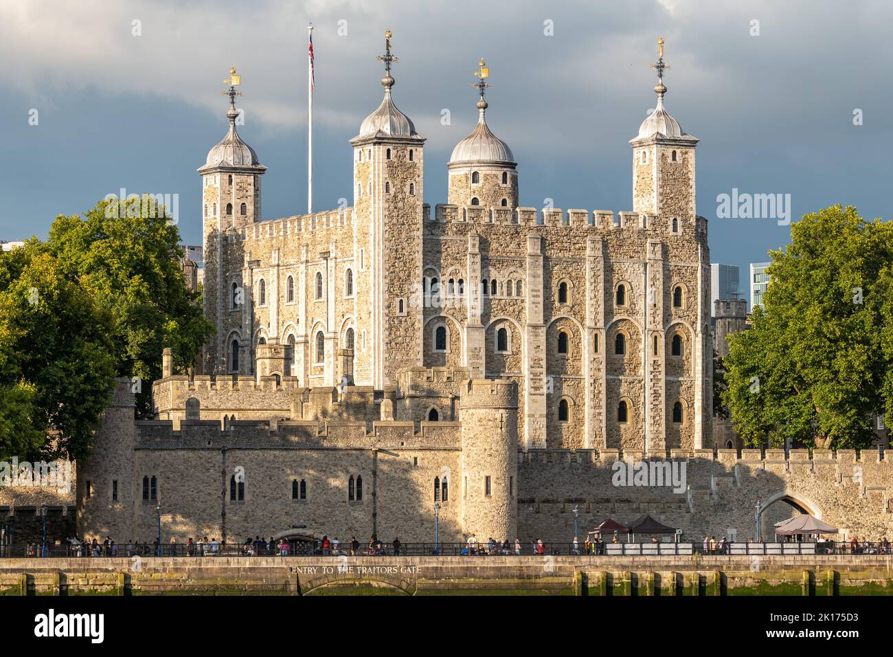 The Tower of London in evening sunshine against a dark foreboding sky. Shot 2 days after the death of Queen Elizabeth II, flags not at half-mast. Stock Photo
