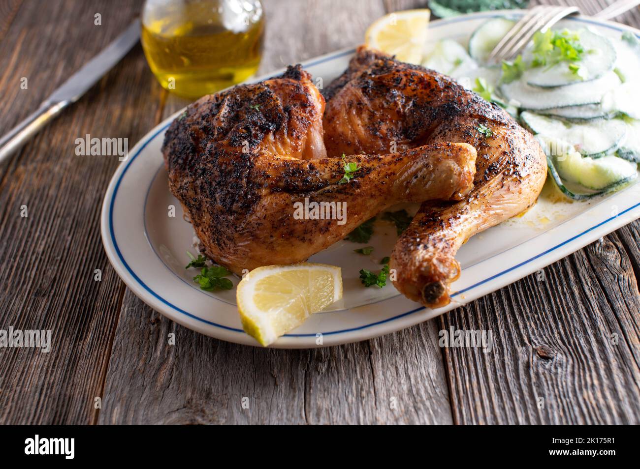 Low carb chicken dish with cucumber salad on plate Stock Photo