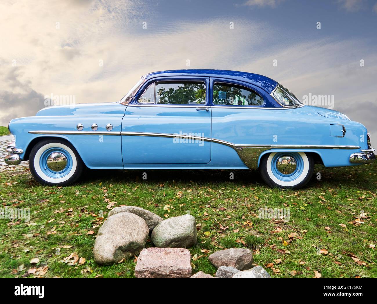Buick eight oldtimer in blue livery on a lawn against cloudy background, Vehicle location Lehnin, Germany, September 11, 2022. Stock Photo