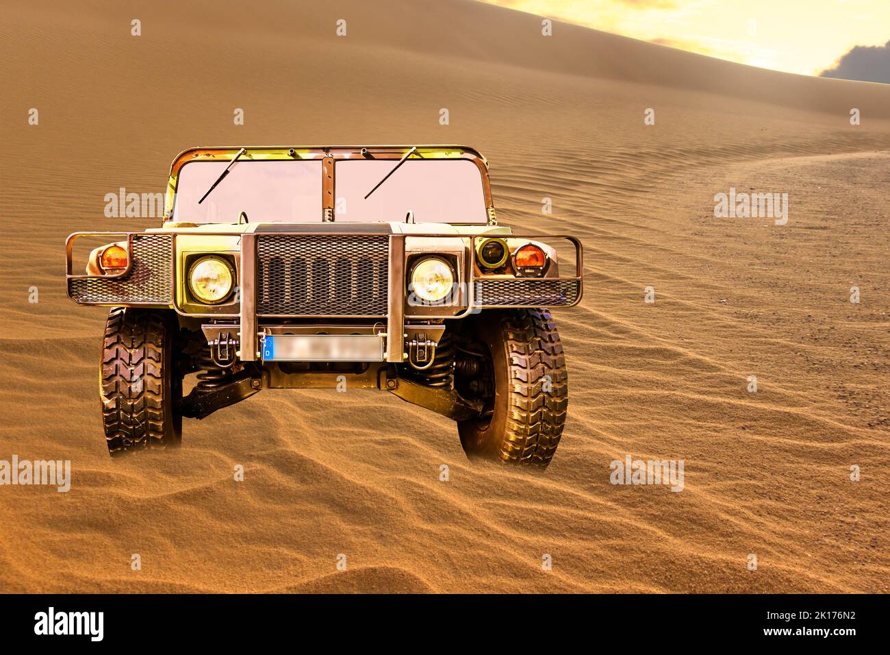 Humvee H1 military vehicle in camouflage on a dune in the sand of the desert, vehicle location Lehnin, Germany, September 11, 2022. Stock Photo