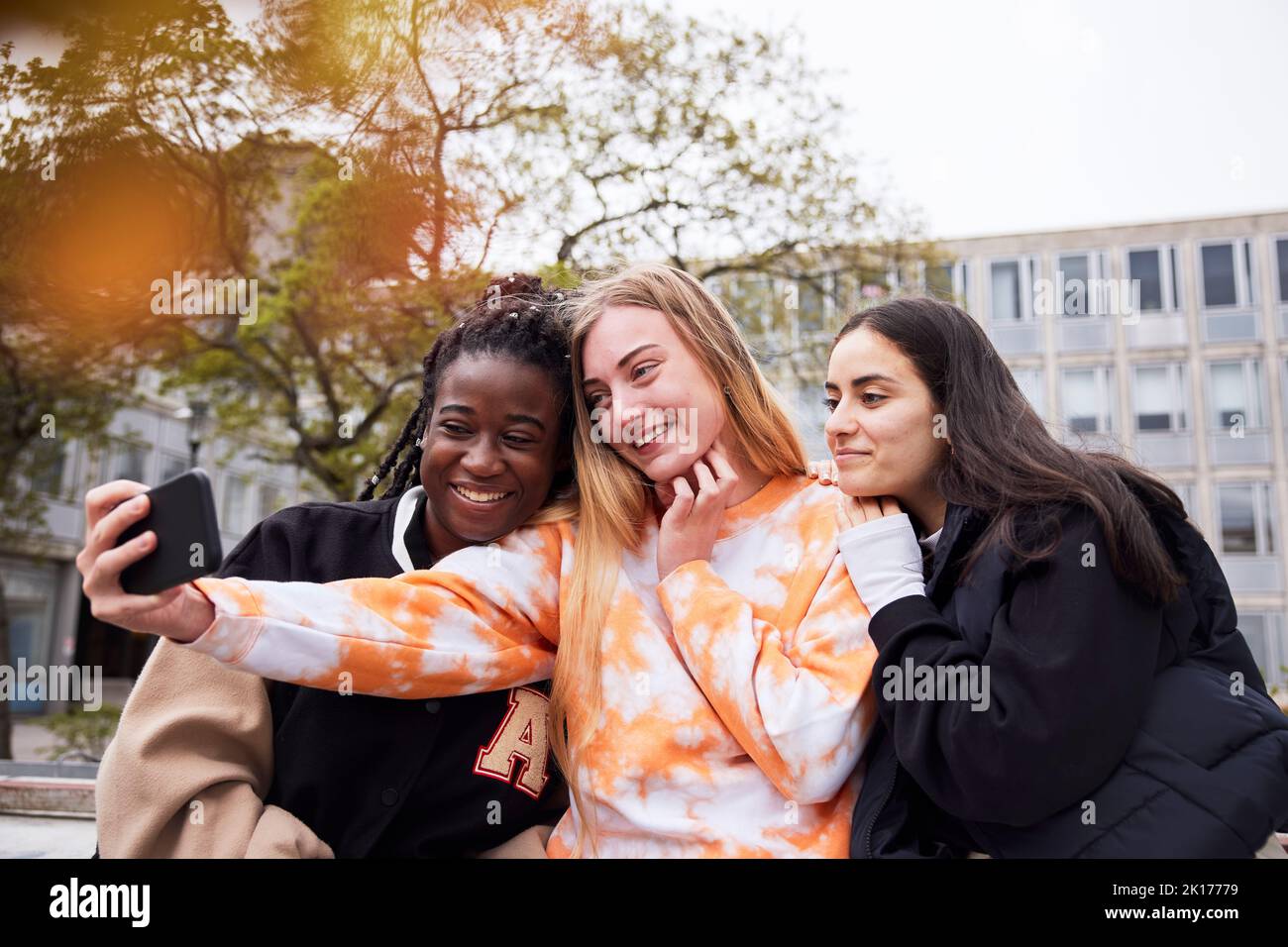 Three young female students taking selfie at campus Stock Photo