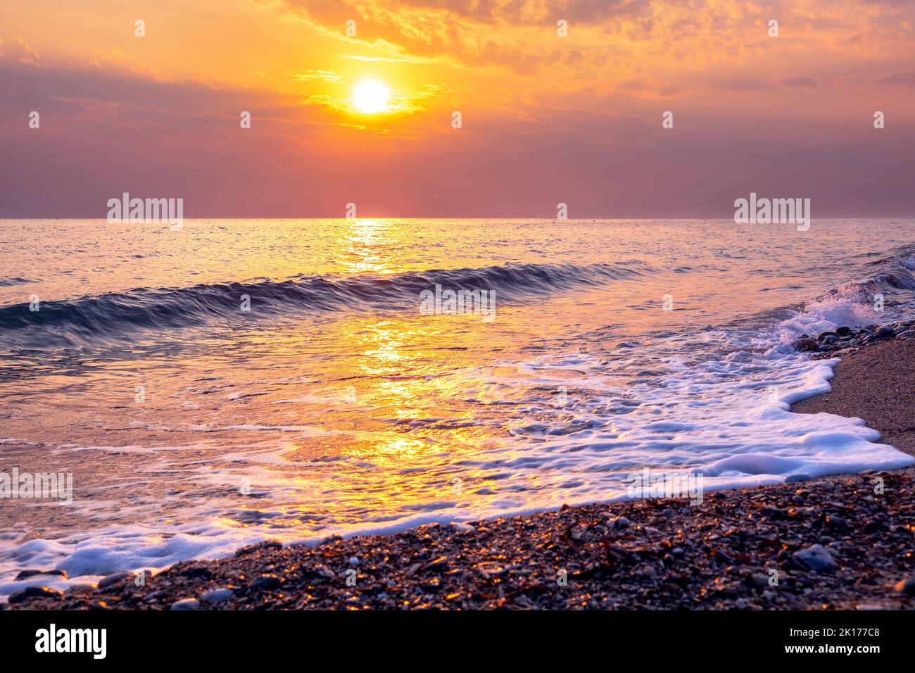 View of Sunrise at the Aegean sea coast. Platamonas, Pieria, Greece Stock Photo