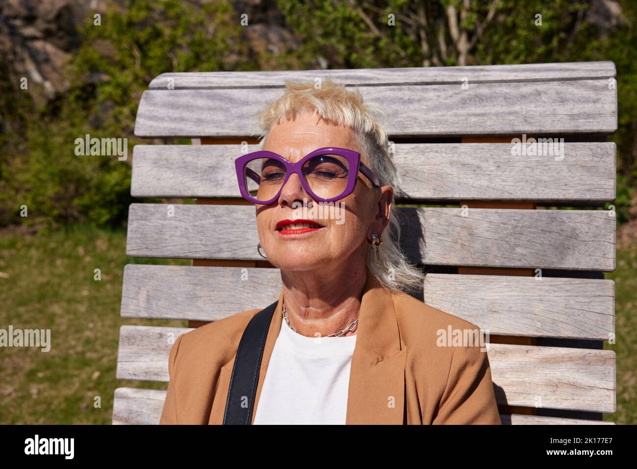Woman sunbathing with eyes closed Stock Photo