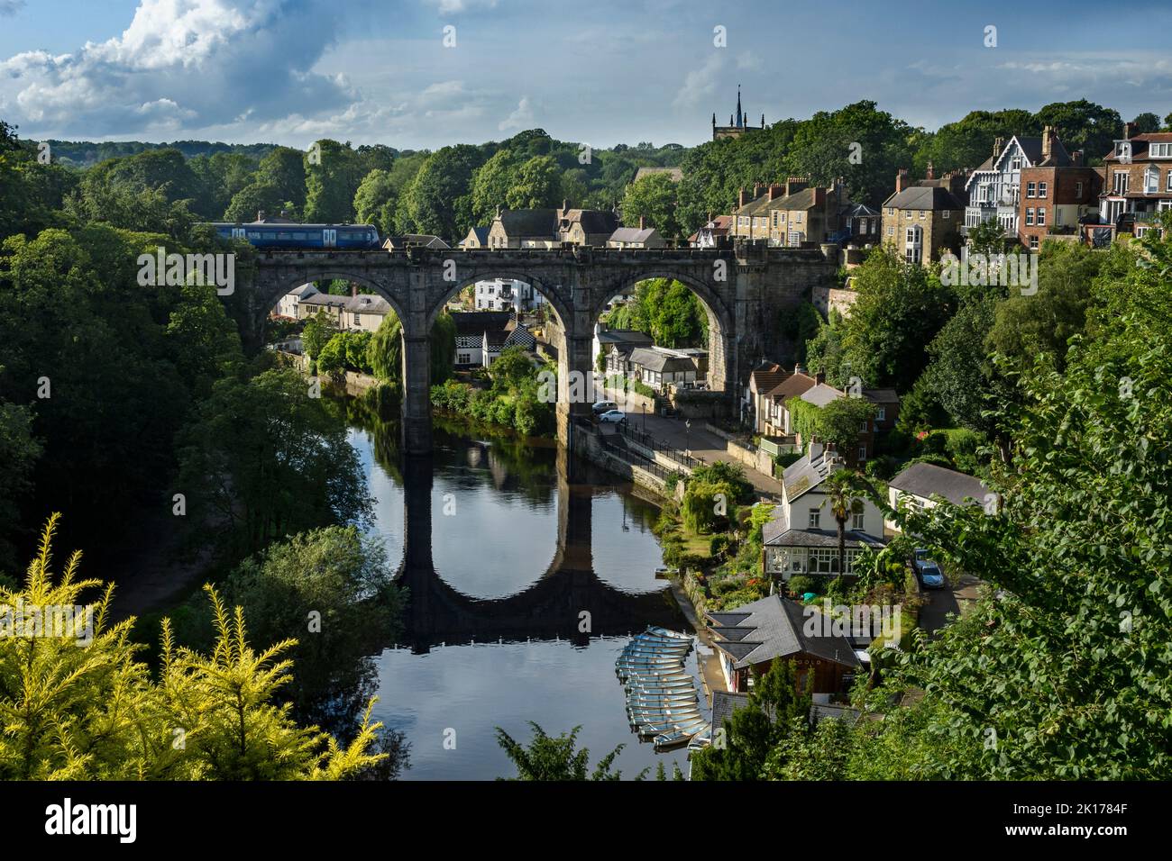 Scenic Knaresborough & River Nidd (passenger rail service loco, viaduct spanning gorge, riverside path, hillside buildings) - Yorkshire, England, UK. Stock Photo