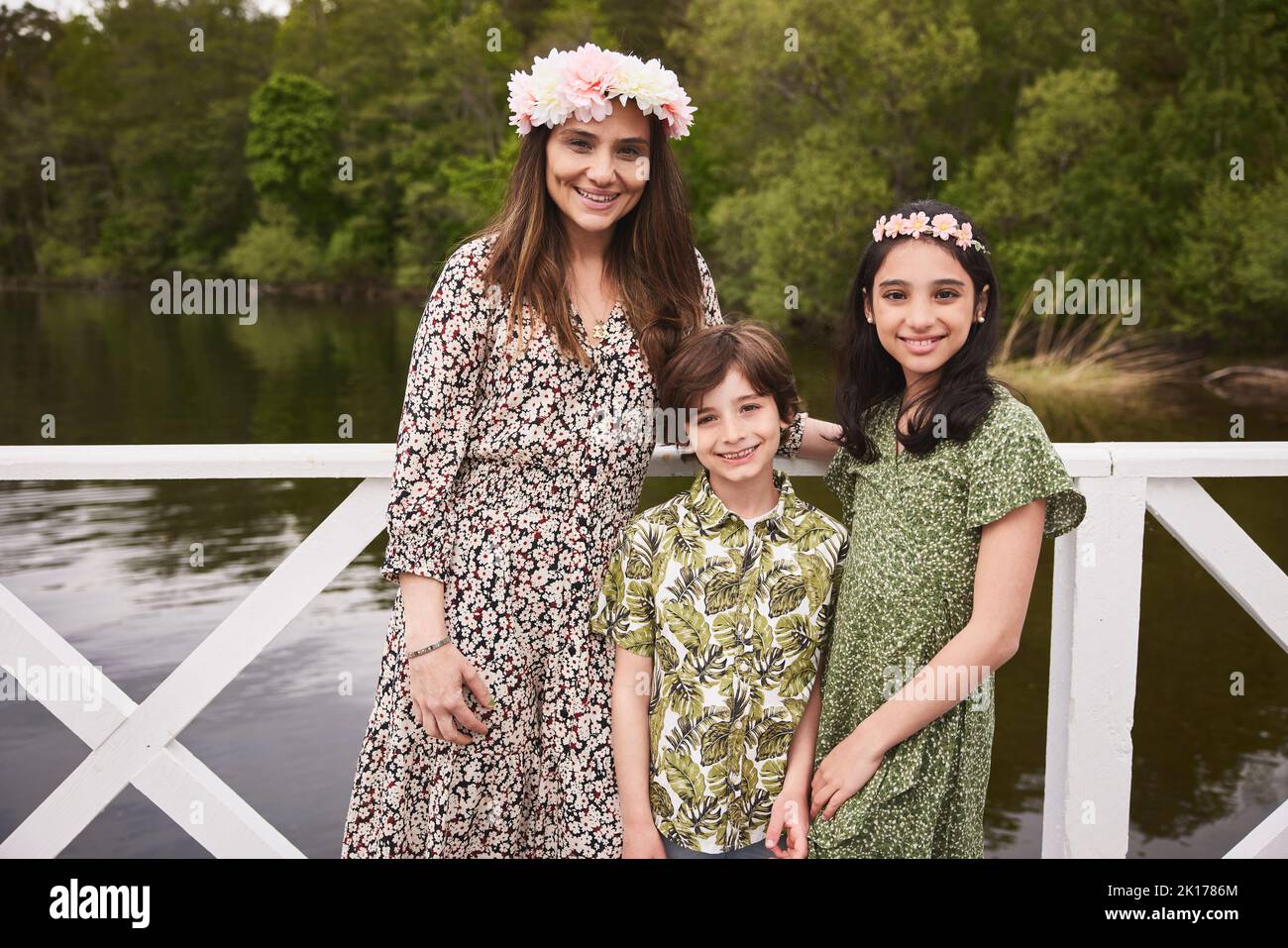Mother with children standing at lake Stock Photo