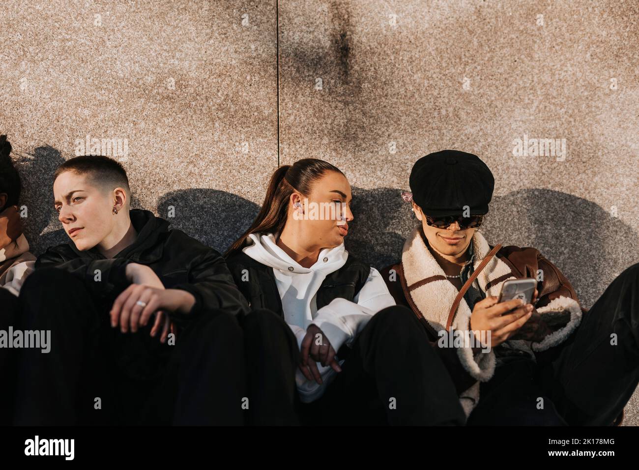 Young friends sitting together Stock Photo