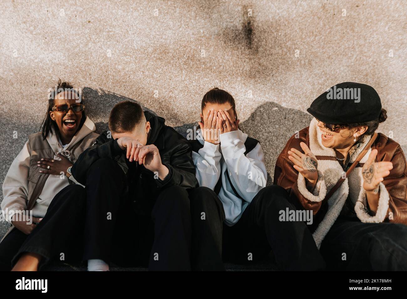 Happy friends sitting together Stock Photo