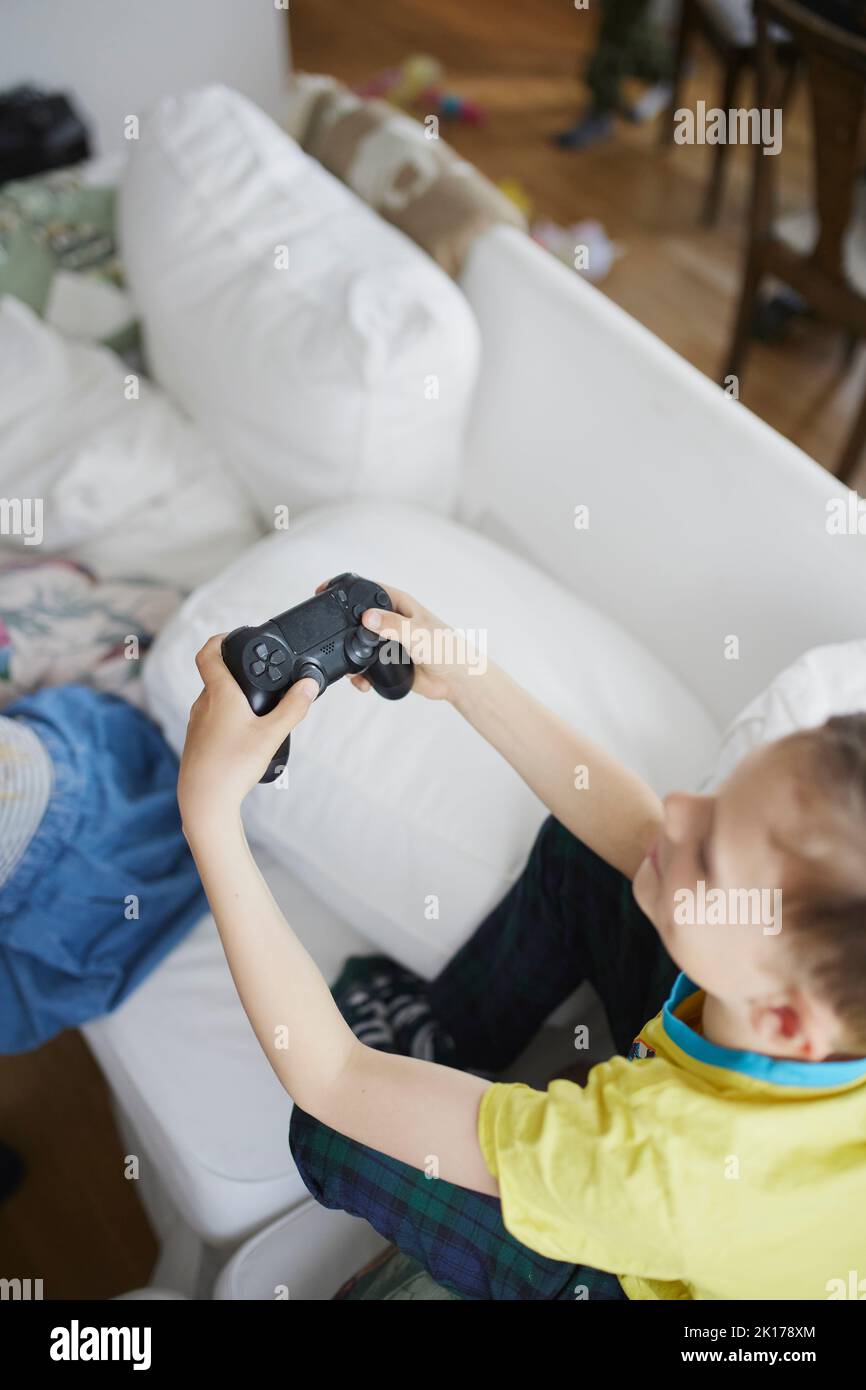 Boy using video game controller Stock Photo