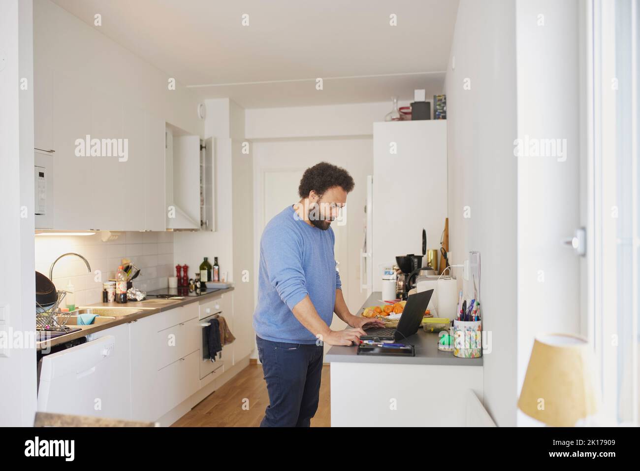 Man working on laptop from home Stock Photo