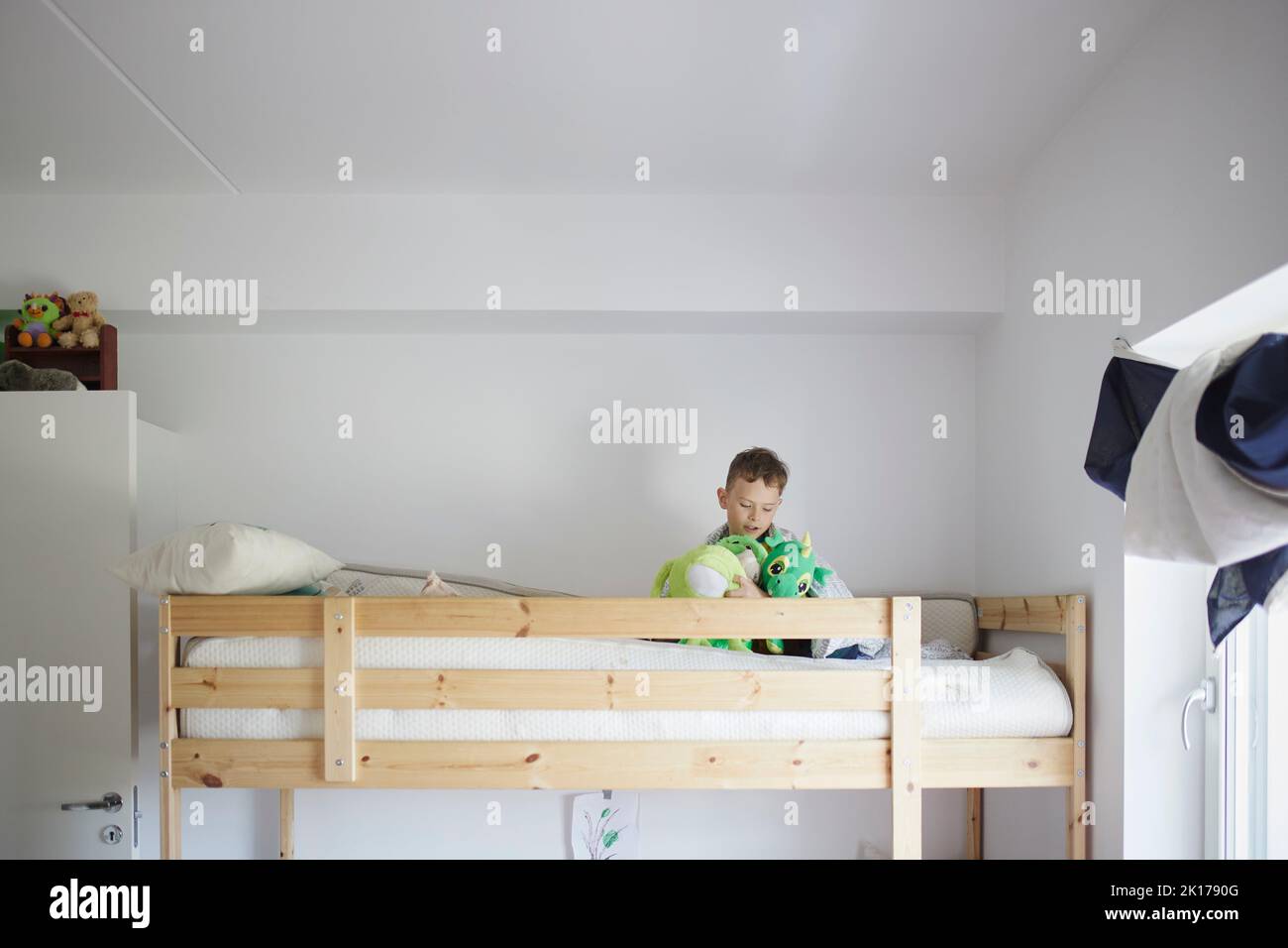 Boy playing in bunk bed Stock Photo