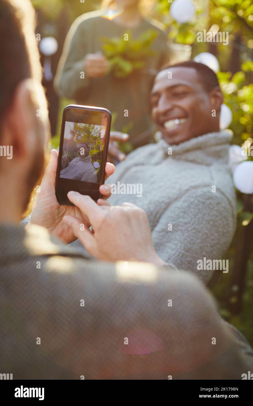 Hand with cell phone taking picture Stock Photo