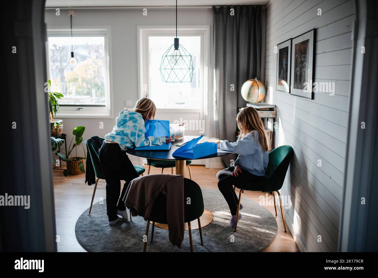 Girls sitting at table Stock Photo