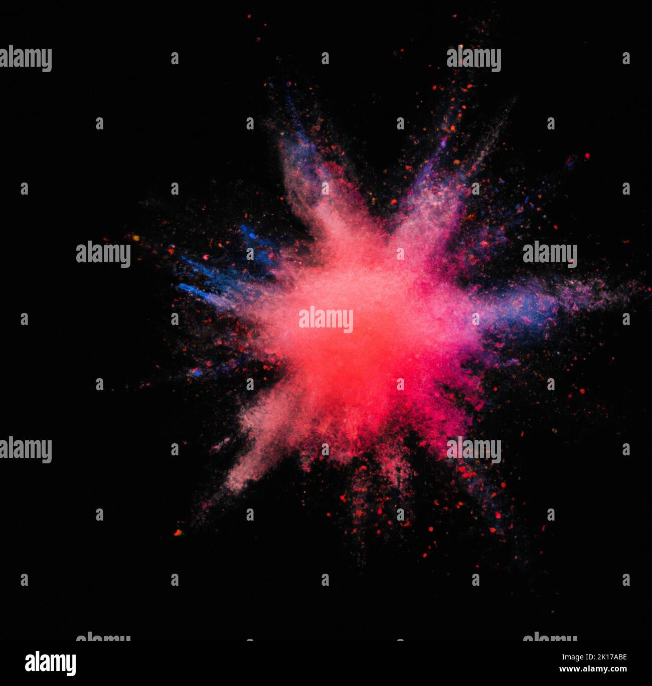 an Explosion of colored powder on a black background Stock Photo - Alamy
