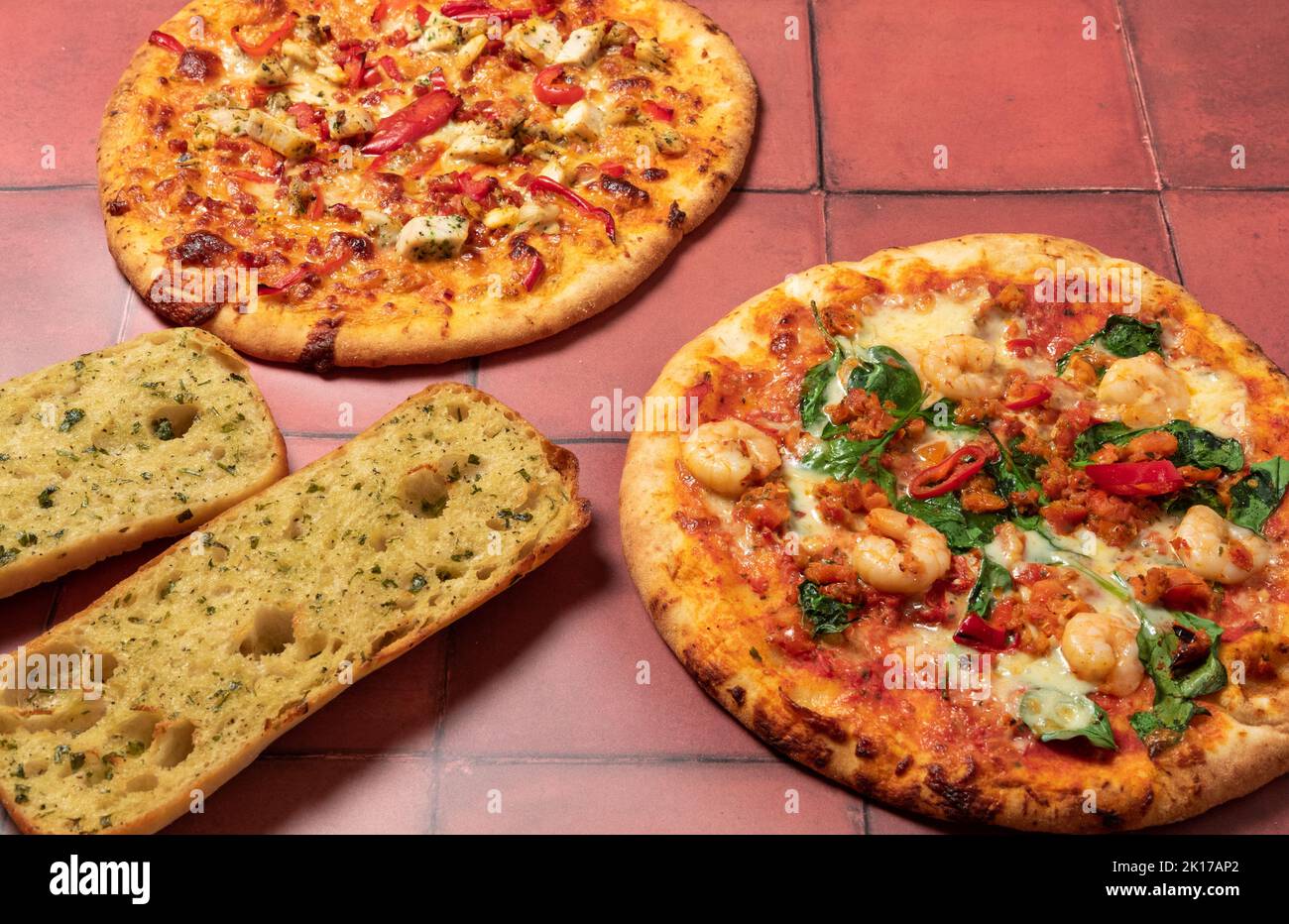 Pizzas and garlic ciabatta Stock Photo