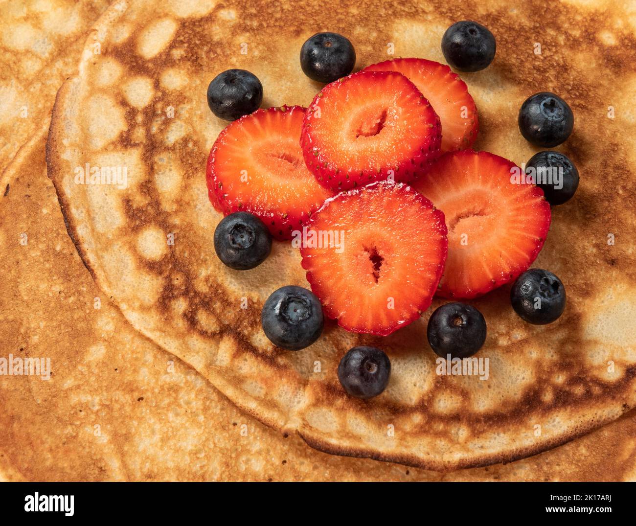 Pancakes with strawberries and blueberries close up Stock Photo