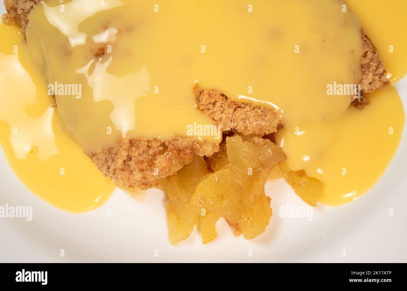 Apple crumble and custard close up Stock Photo