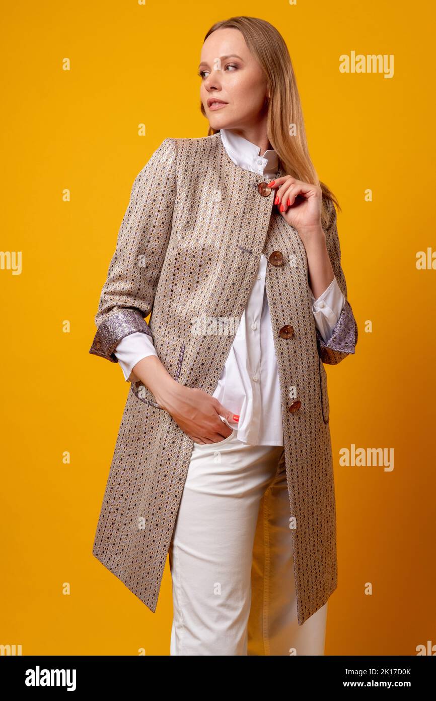 Female fashion. Business look. Fall collection. Elegance confidence. Graceful model in stylish beige smart casual outfit ethnic blazer coat posing iso Stock Photo