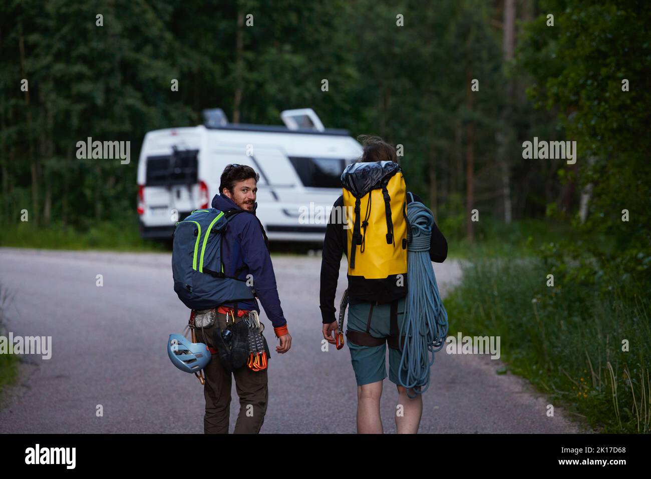 Rock climbers walking towards van Stock Photo Alamy
