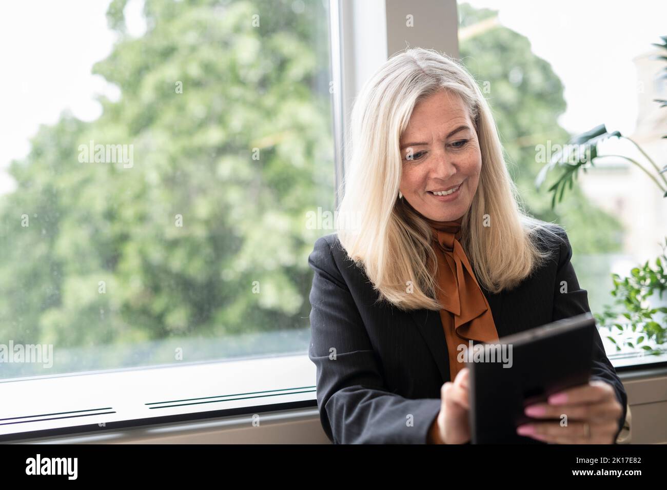 Smiling businesswoman using digital tablet Stock Photo