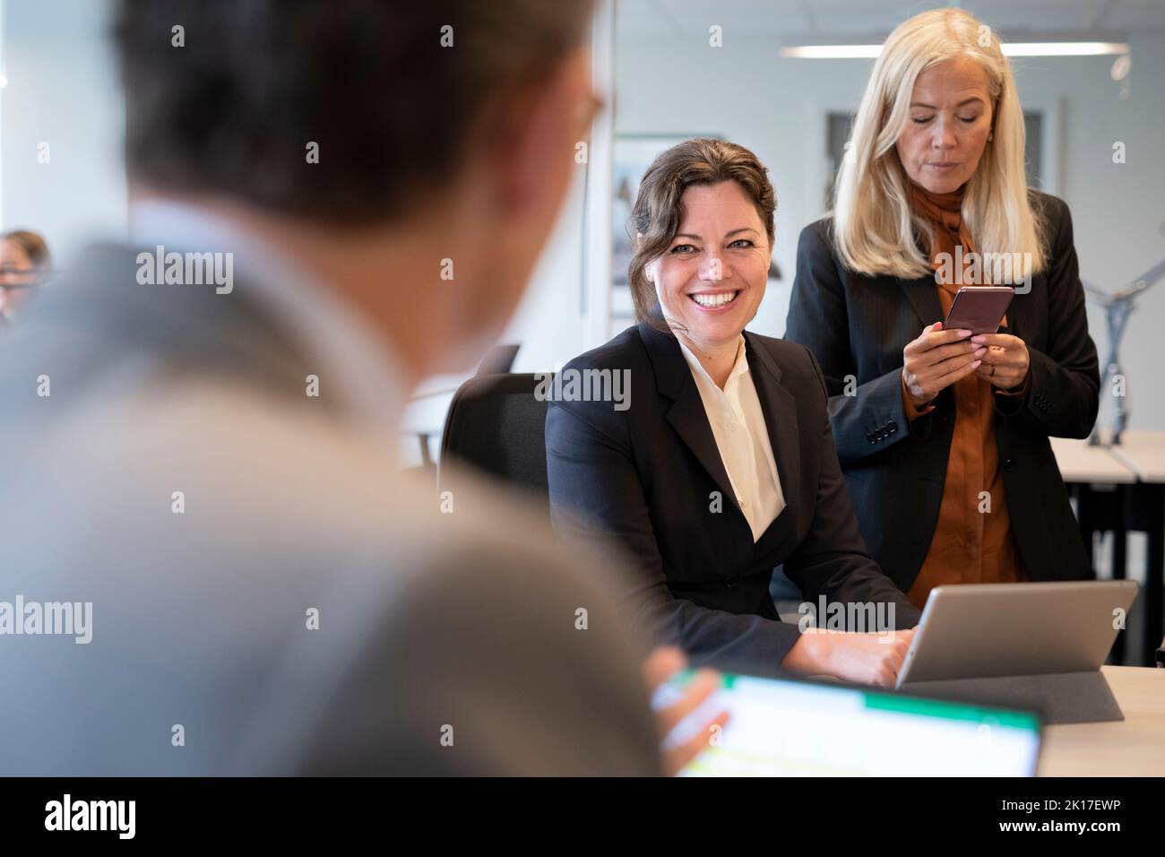 Businesswomen talking in office Stock Photo