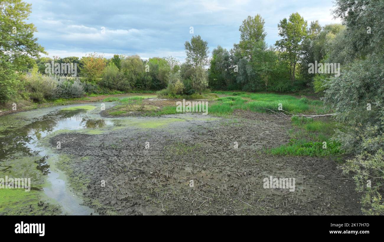 Very drought wetland, swamp drone aerial pond drying up the soil cracked crust earth climate