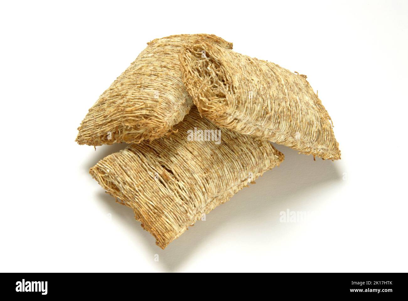 Shredded wheat cereal on white background cut out Stock Photo
