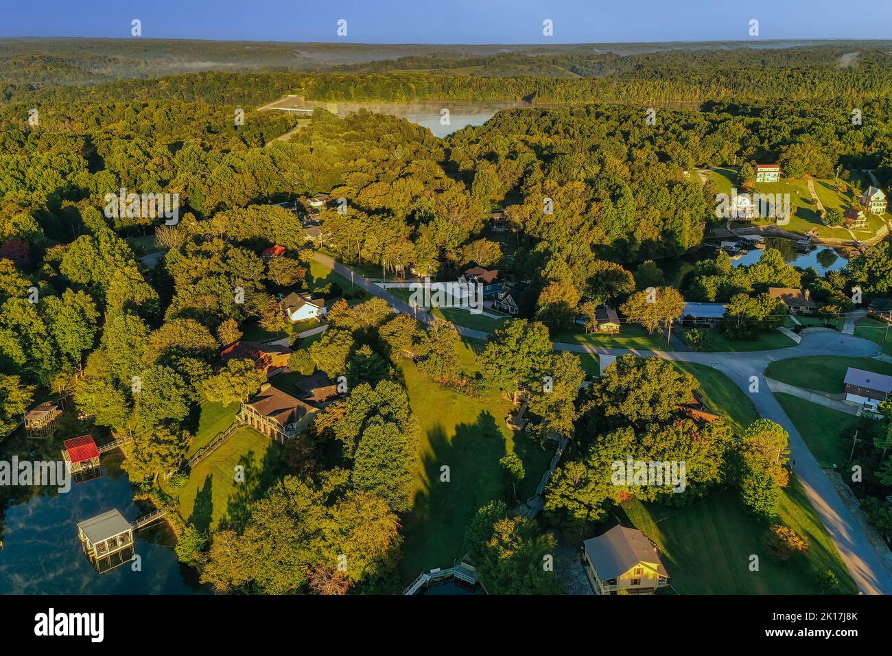 Aerial overhead view of lakefront and lake view homes and floating boat