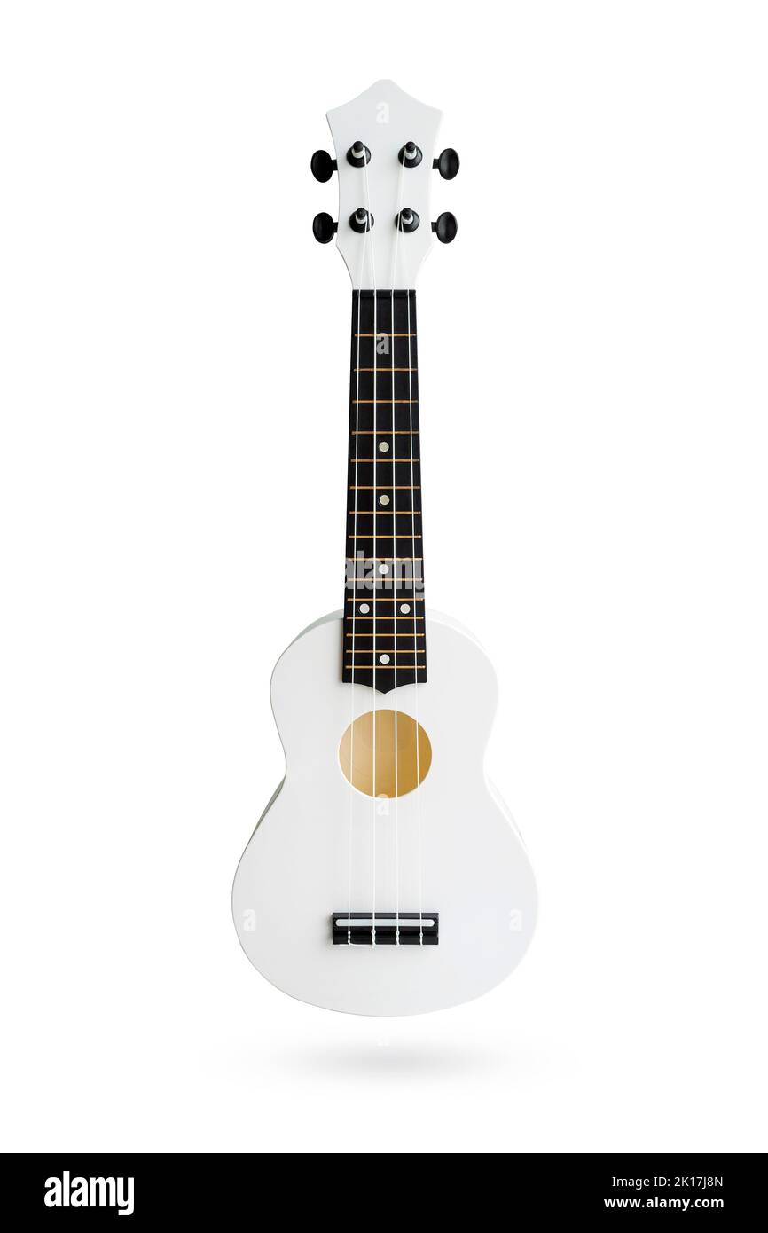 Small Hawaiian four stringed ukulele guitar isolated on white background with clipping path. Musical instruments shop or learning concept Stock Photo