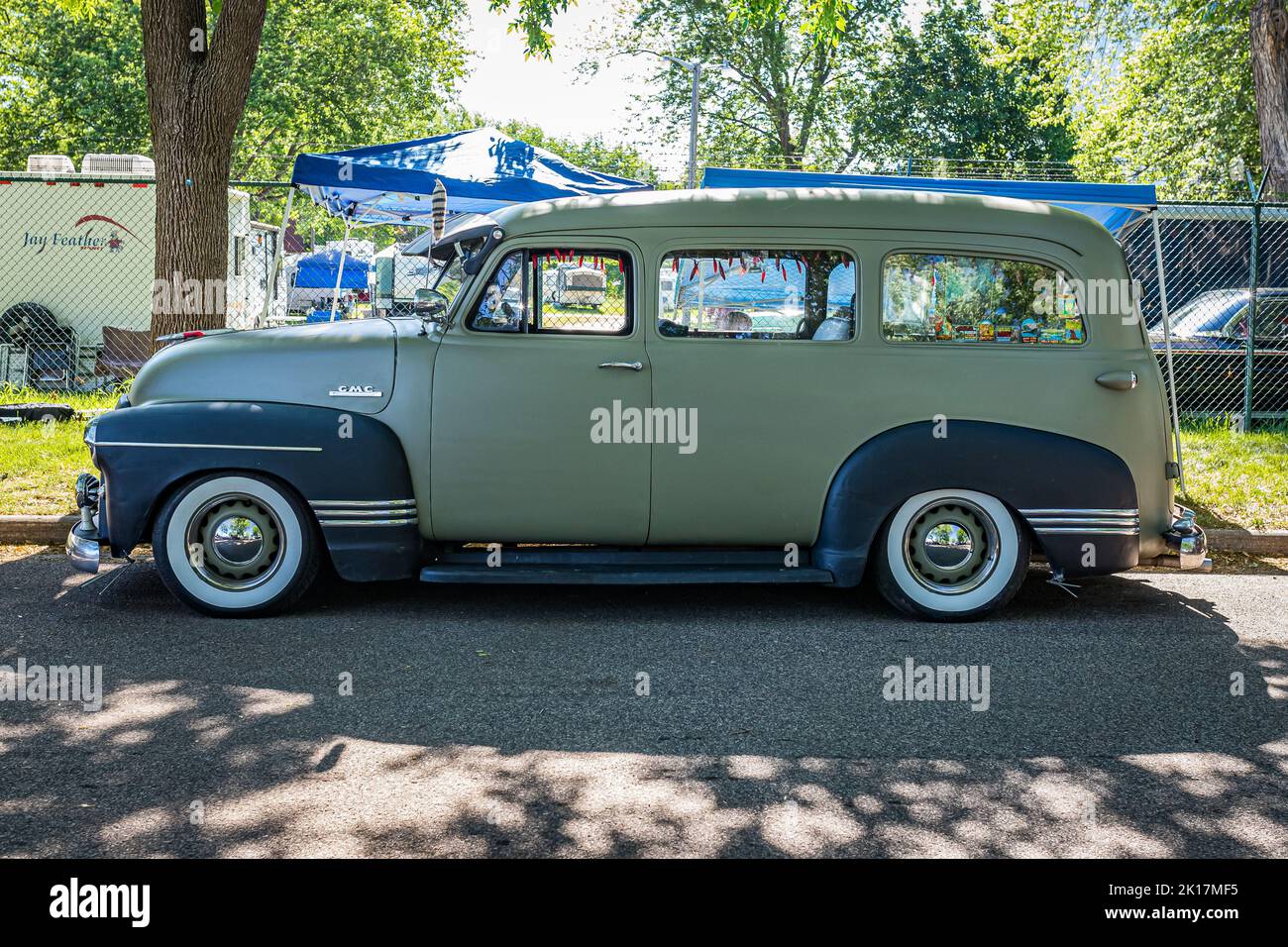 Falcon Heights, MN - June 18, 2022: High perspective side view of a 1950 GMC Suburban Carryall at a local car show. Stock Photo