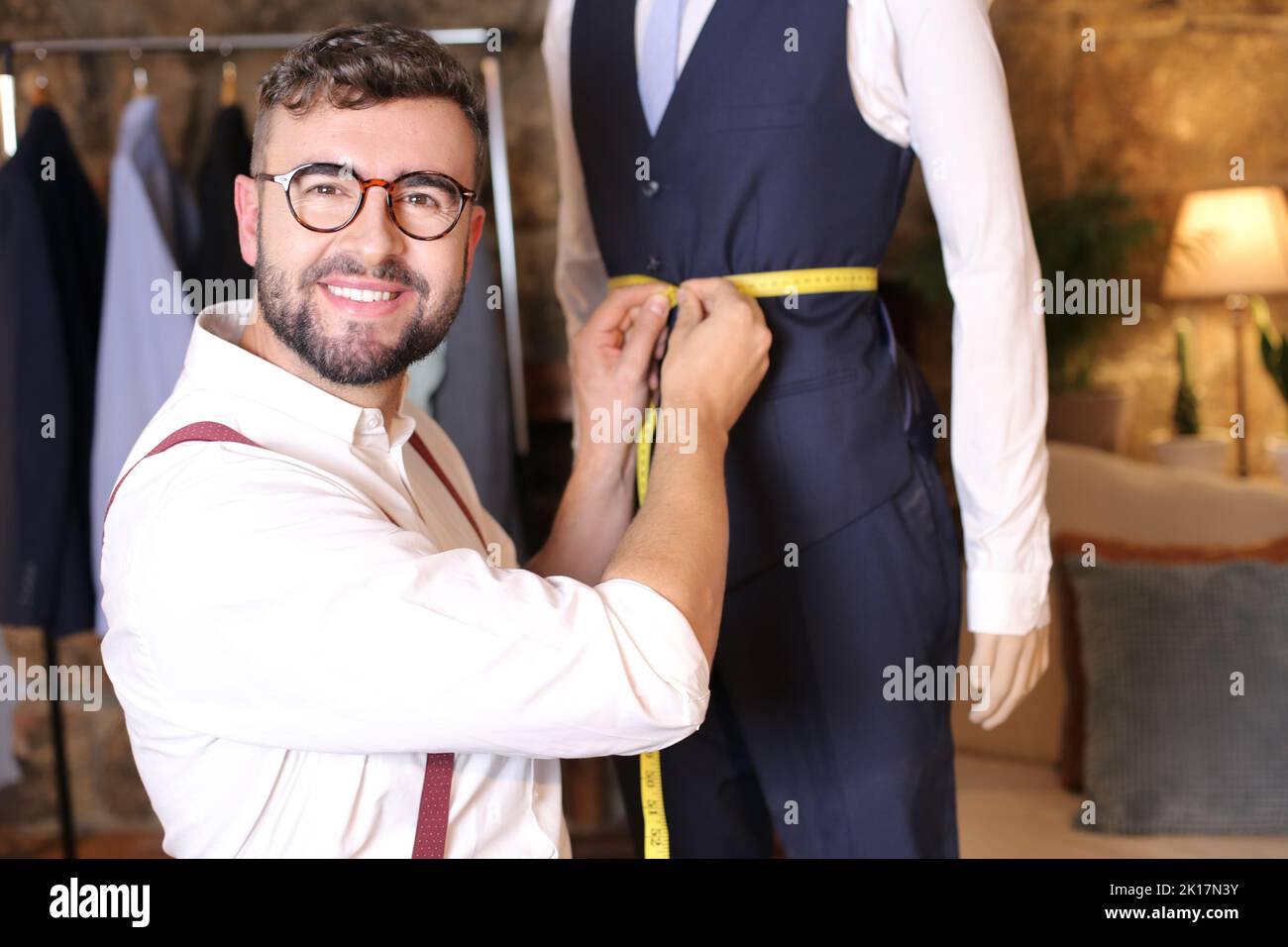 Male fashion designer taking some measurements Stock Photo Alamy