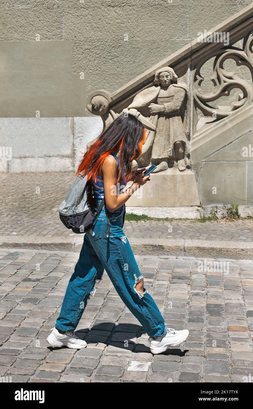 Fashionable girl with multi-colored hair in torn jeans Stock Photo