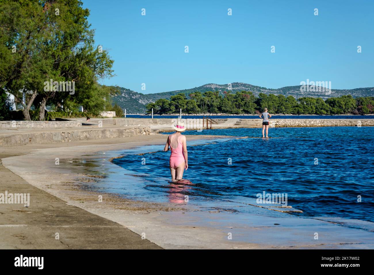 Two women on beach, Veli Iz, Island of Iz, Zadar archipelago, Dalmatia, Croatia Stock Photo