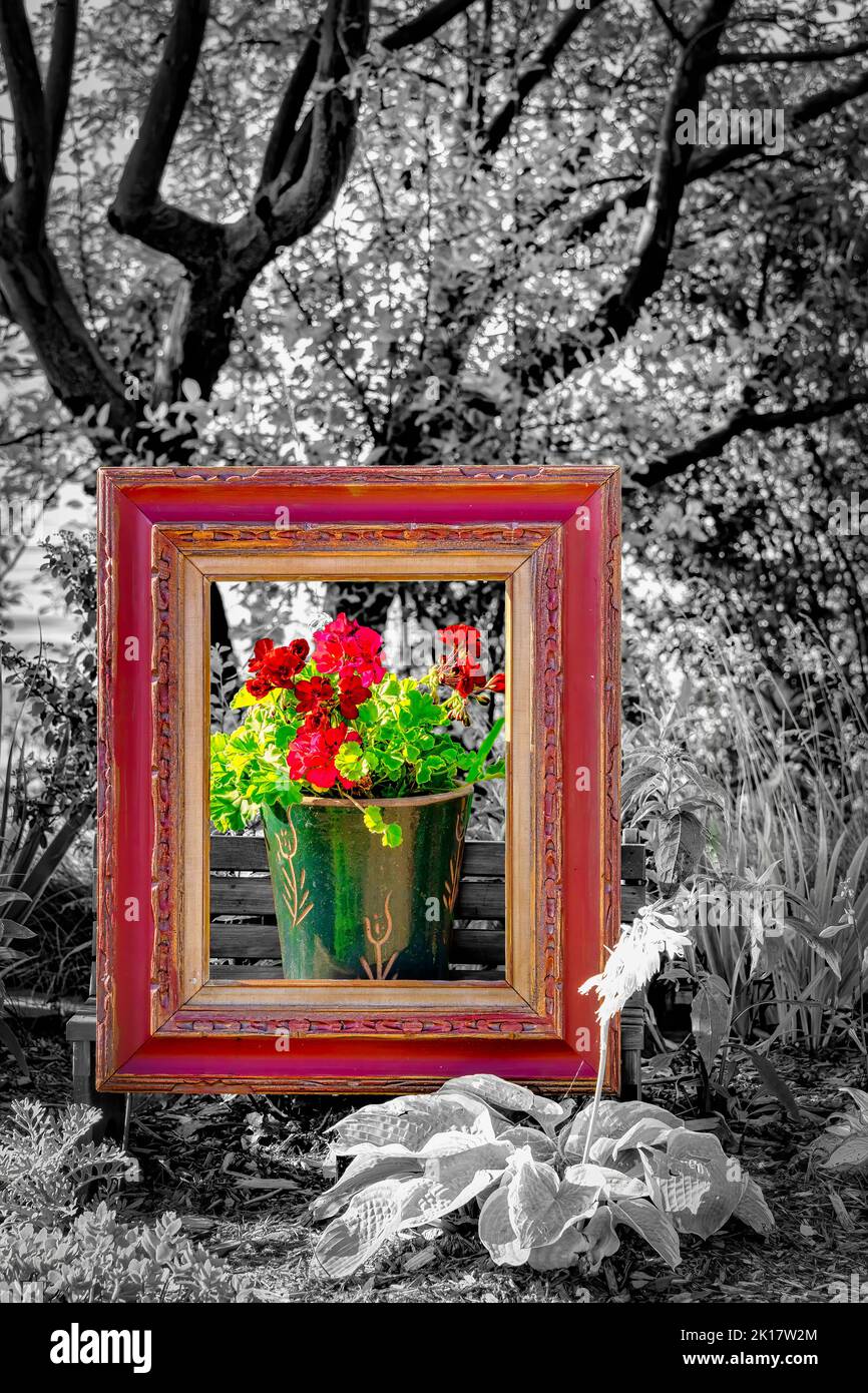 A bucket of flowers inside a picture frame sits in a colorful garden on the Mariner's Trail between Manitowoc and Two Rivers, Wisconsin. Stock Photo
