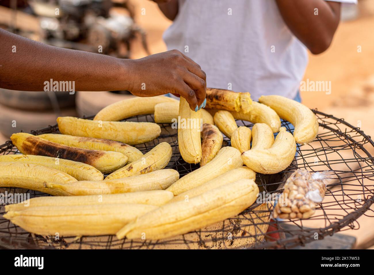 plantain being roasted roadside, people wanting to buy Stock Photo
