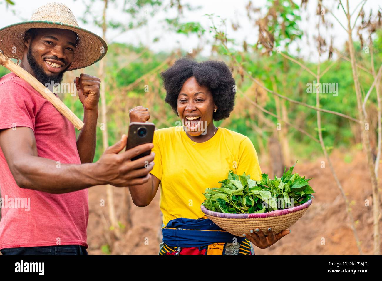 african farmers checking their phone rejoice Stock Photo