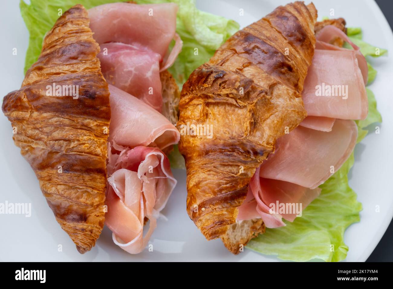 Croissants sandwiches with prosciutto(jamon, cured ham, prosciutto