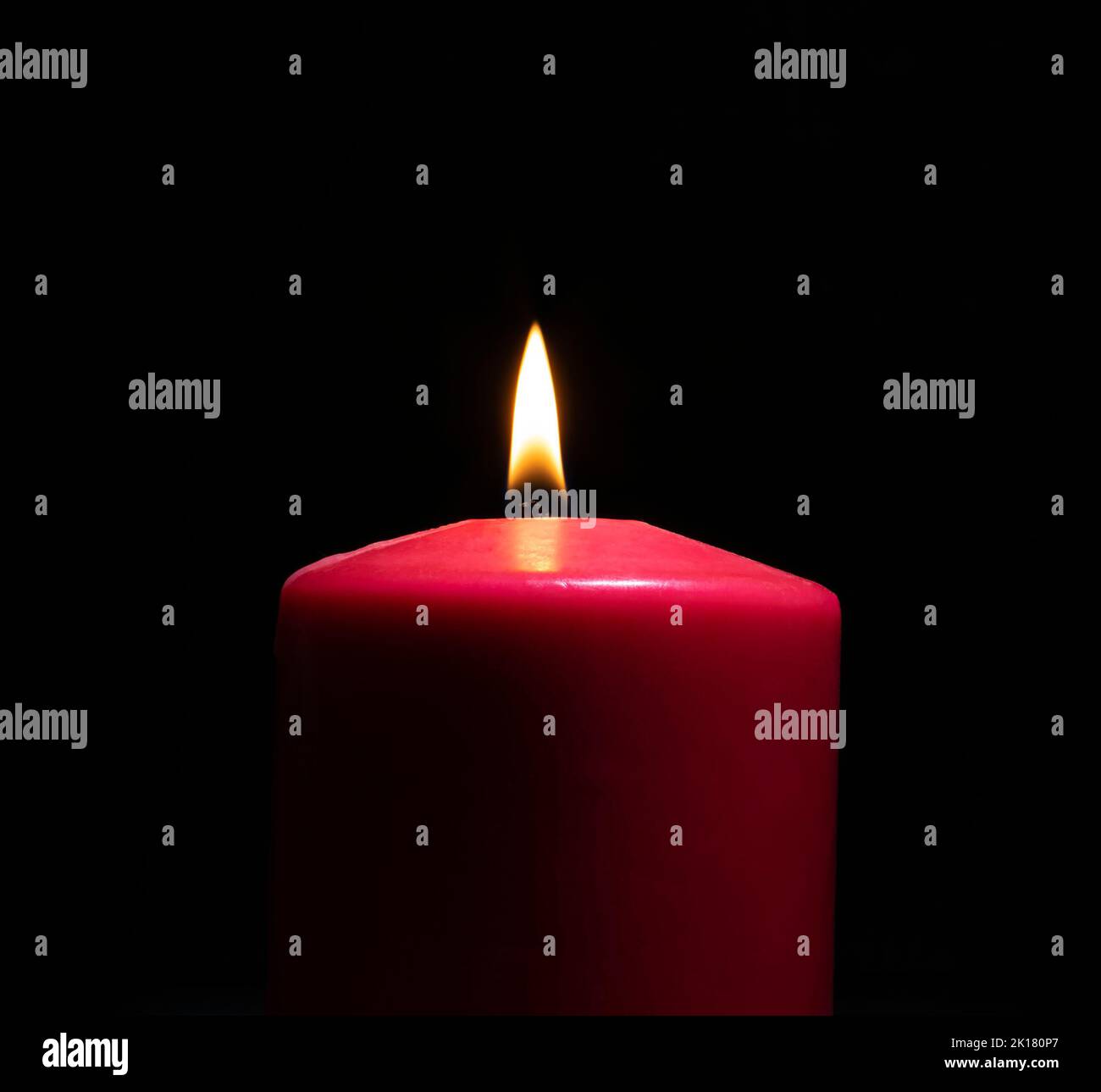Red burning candle in front of a black background Stock Photo Alamy