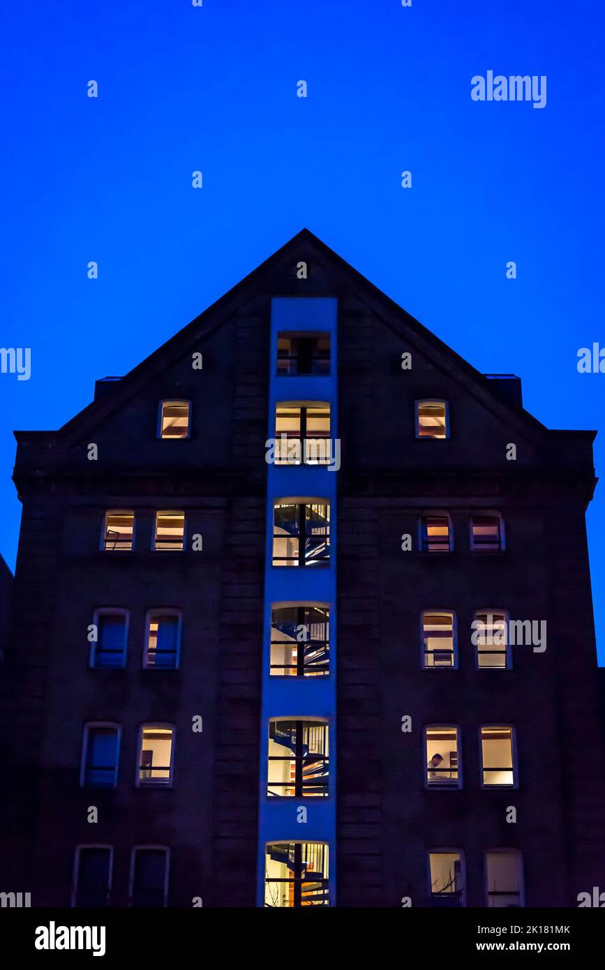 House with lit windows at night, Copenhagen, Denmark Stock Photo
