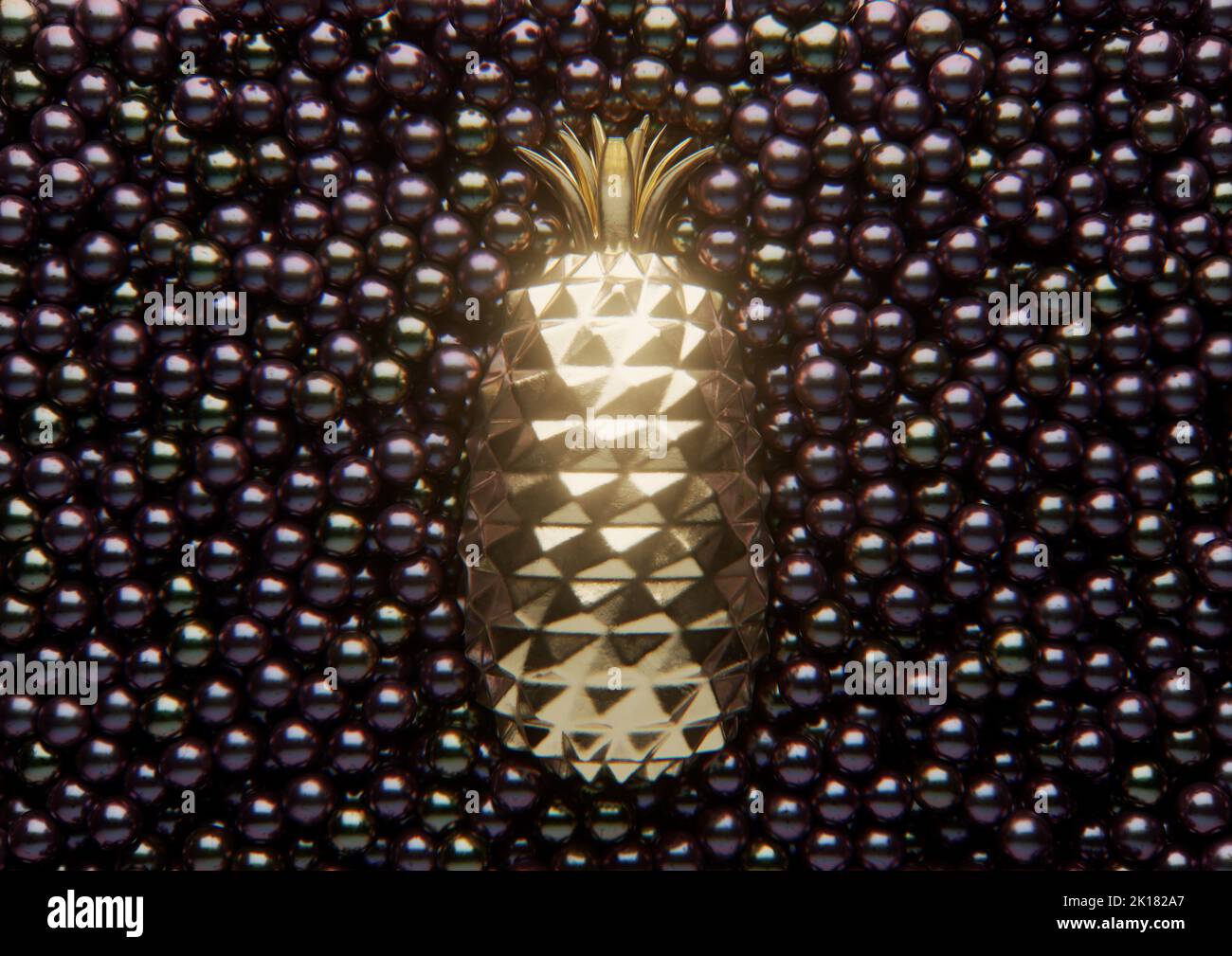 A golden pineapple surrounded by an array of black shiny pearls spread out to form an solid background - 3D render Stock Photo