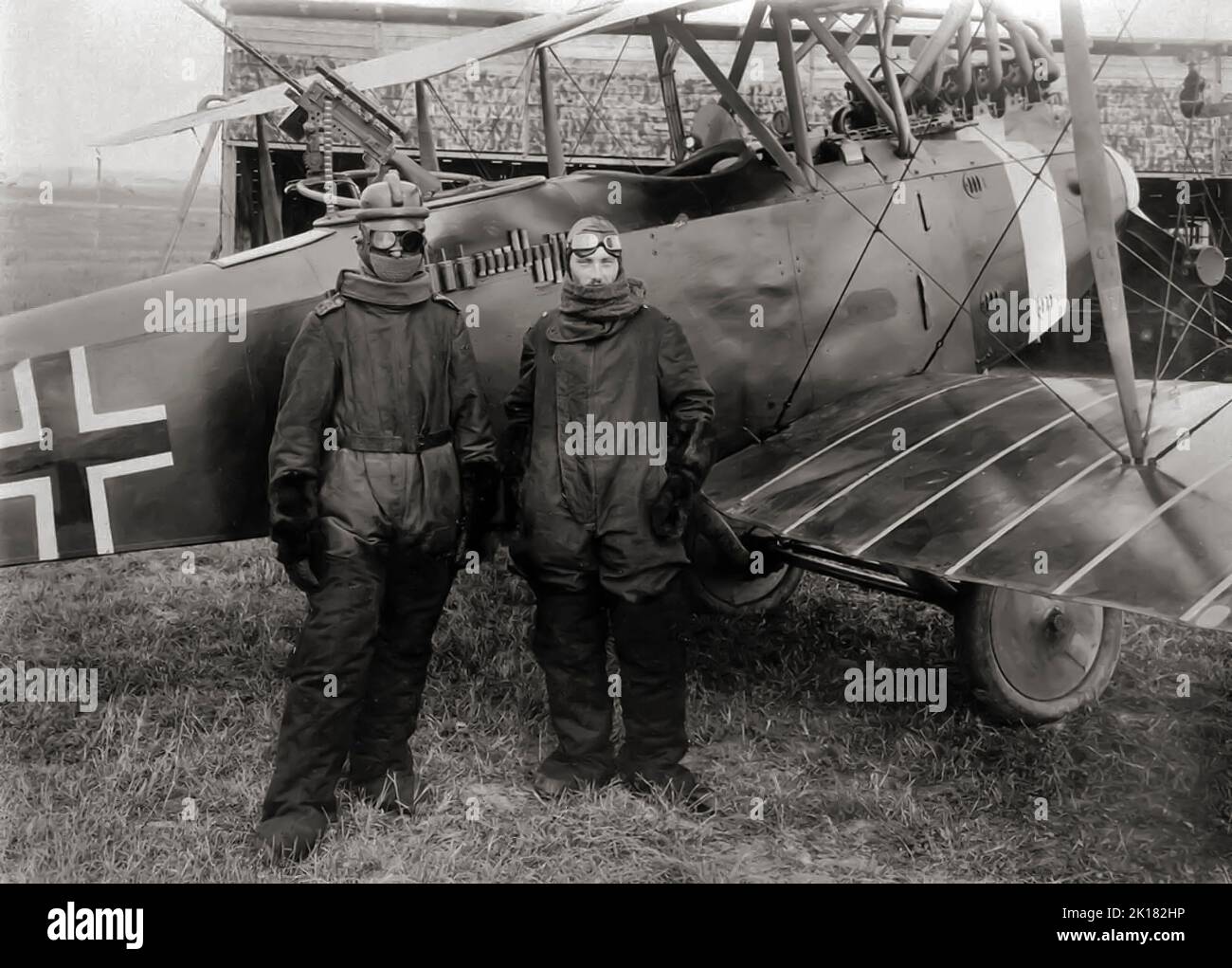 German pilot Richard Scholl and his co-pilot Lieutenant Anderer, in flight gear beside their Hannover CL.II biplane in 1918. The Hannover CL.II was an escort fighter, produced in Germany during World War I, designed in response to a 1917 requirement fora machine to protect reconnaissance aircraft over enemy territory. Stock Photo