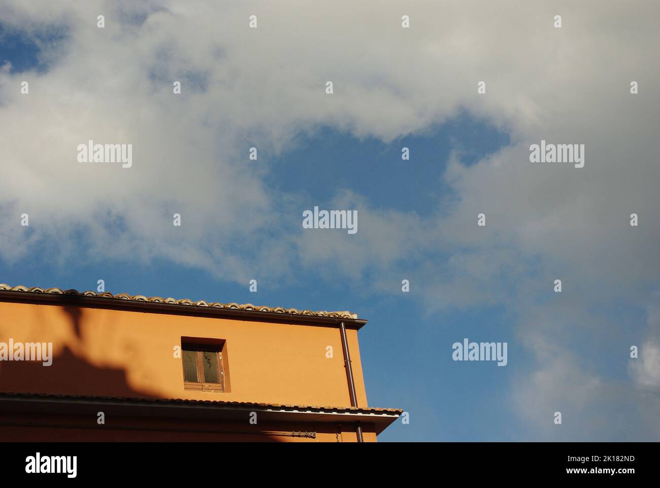 Part of a house with the background the blue sky and white clouds Stock ...