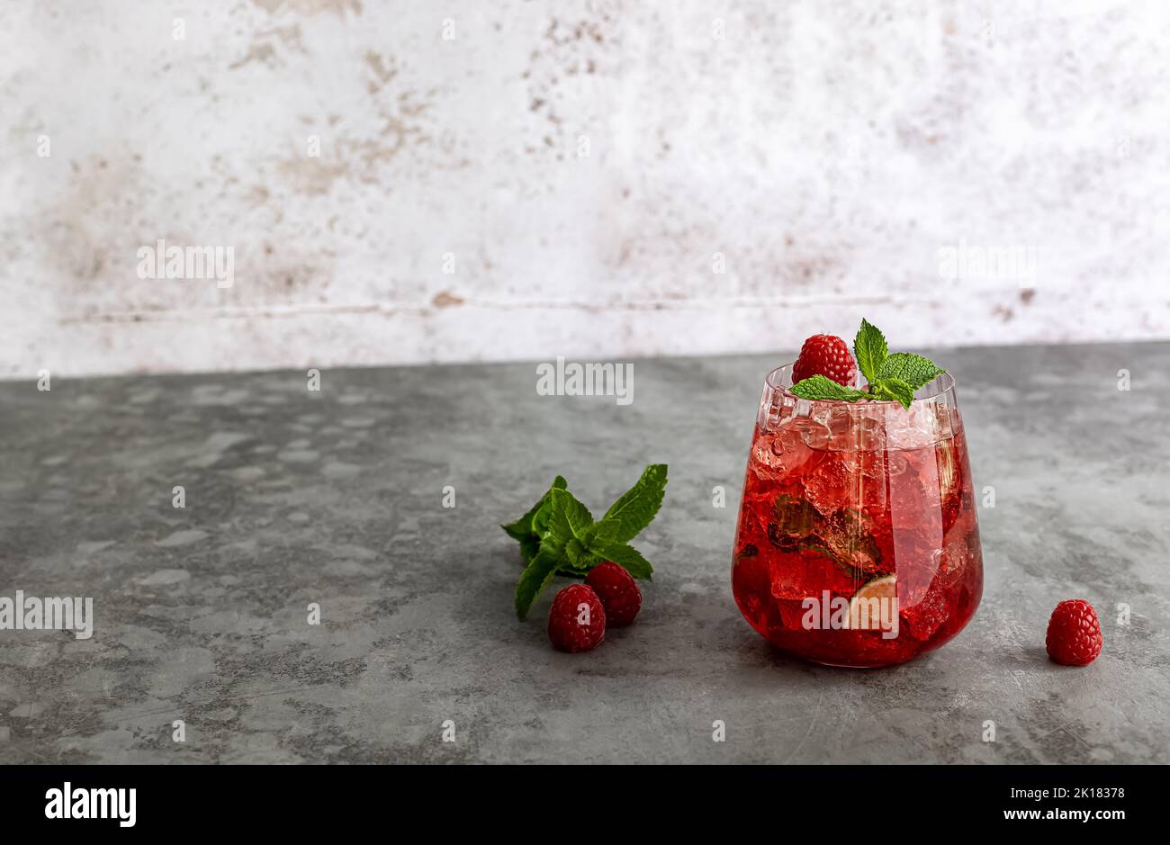 A glass of raspberry daiquiri, alcoholic cocktail or mocktail with raspberry, soda water, lime juice. Stock Photo