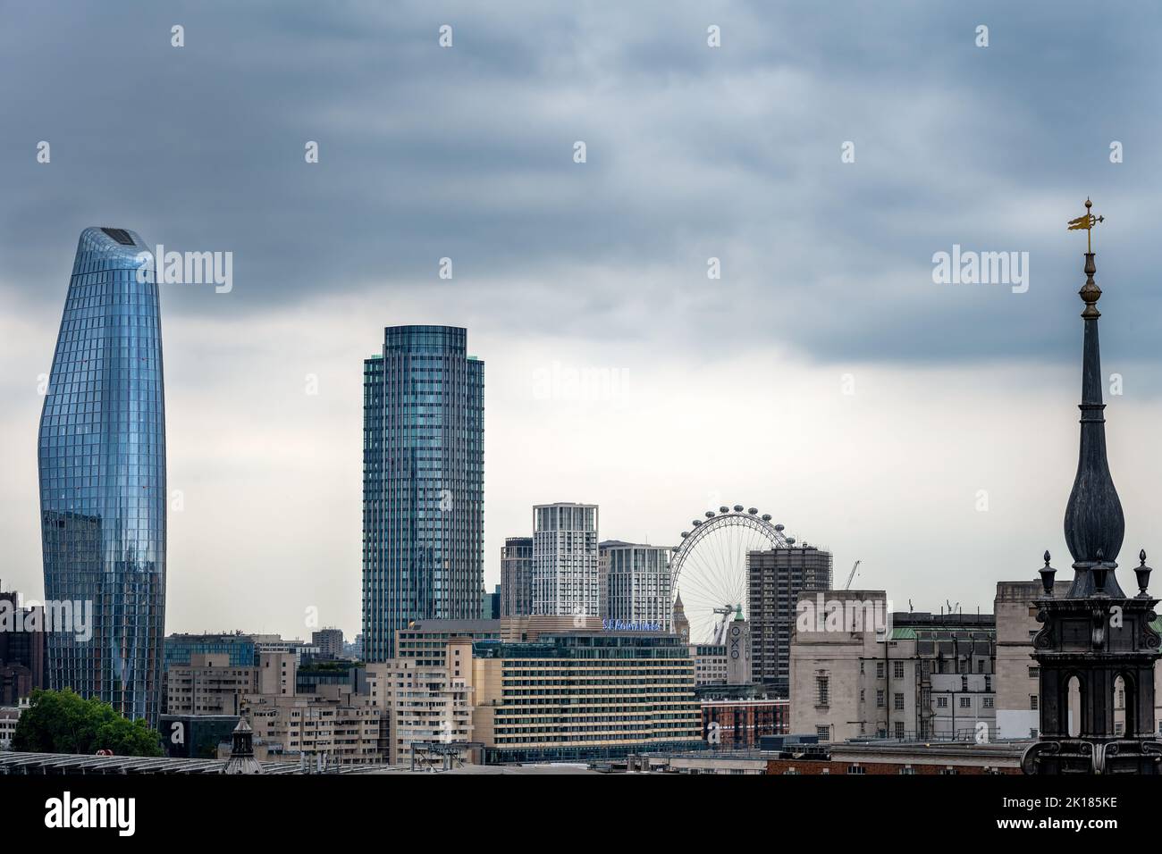 LONDON, ENGLAND - JULY 21st, 2022: View of some iconic buildings of London, the London Eye and the steeple of St Augustine Watling Street Stock Photo