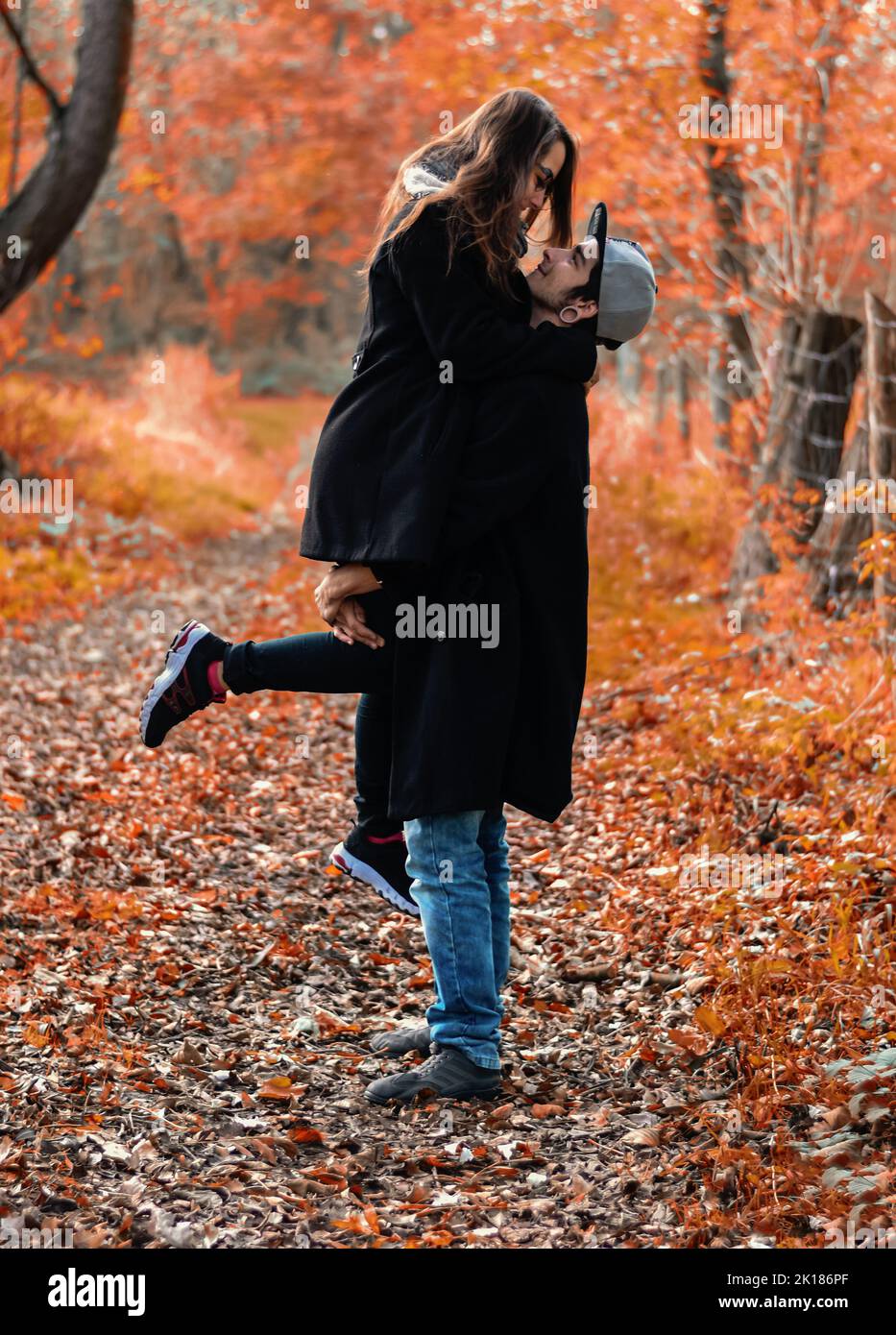 boy holds his girlfriend in his arms, autumn love scene Stock Photo Alamy