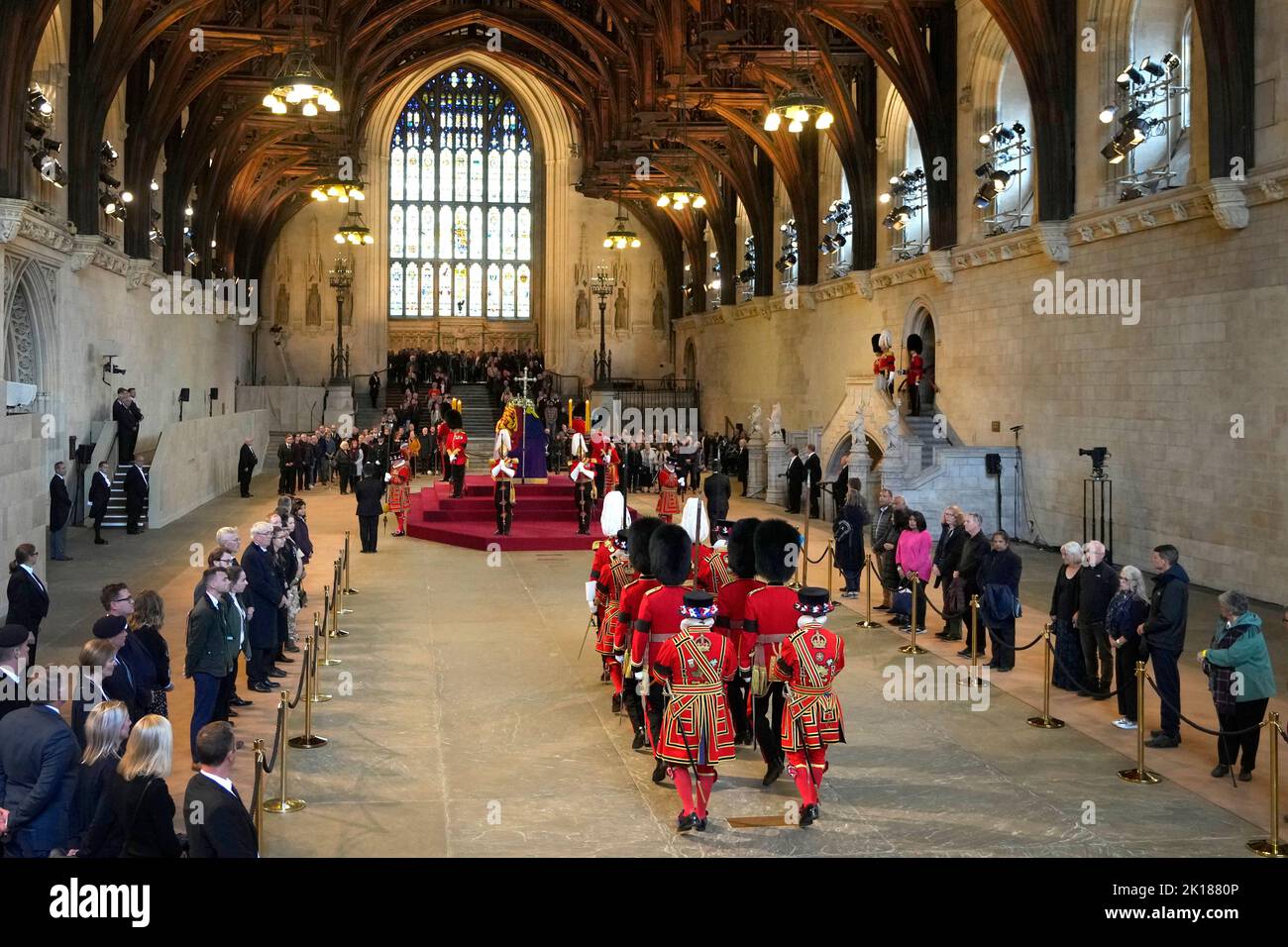 Guards are changed as members of the public file past the coffin of Queen Elizabeth II, draped in the Royal Standard with the Imperial State Crown and the Sovereign's orb and sceptre, lying in state on the catafalque in Westminster Hall, at the Palace of Westminster, London, ahead of her funeral on Monday. Picture date: Friday September 16, 2022. Stock Photo