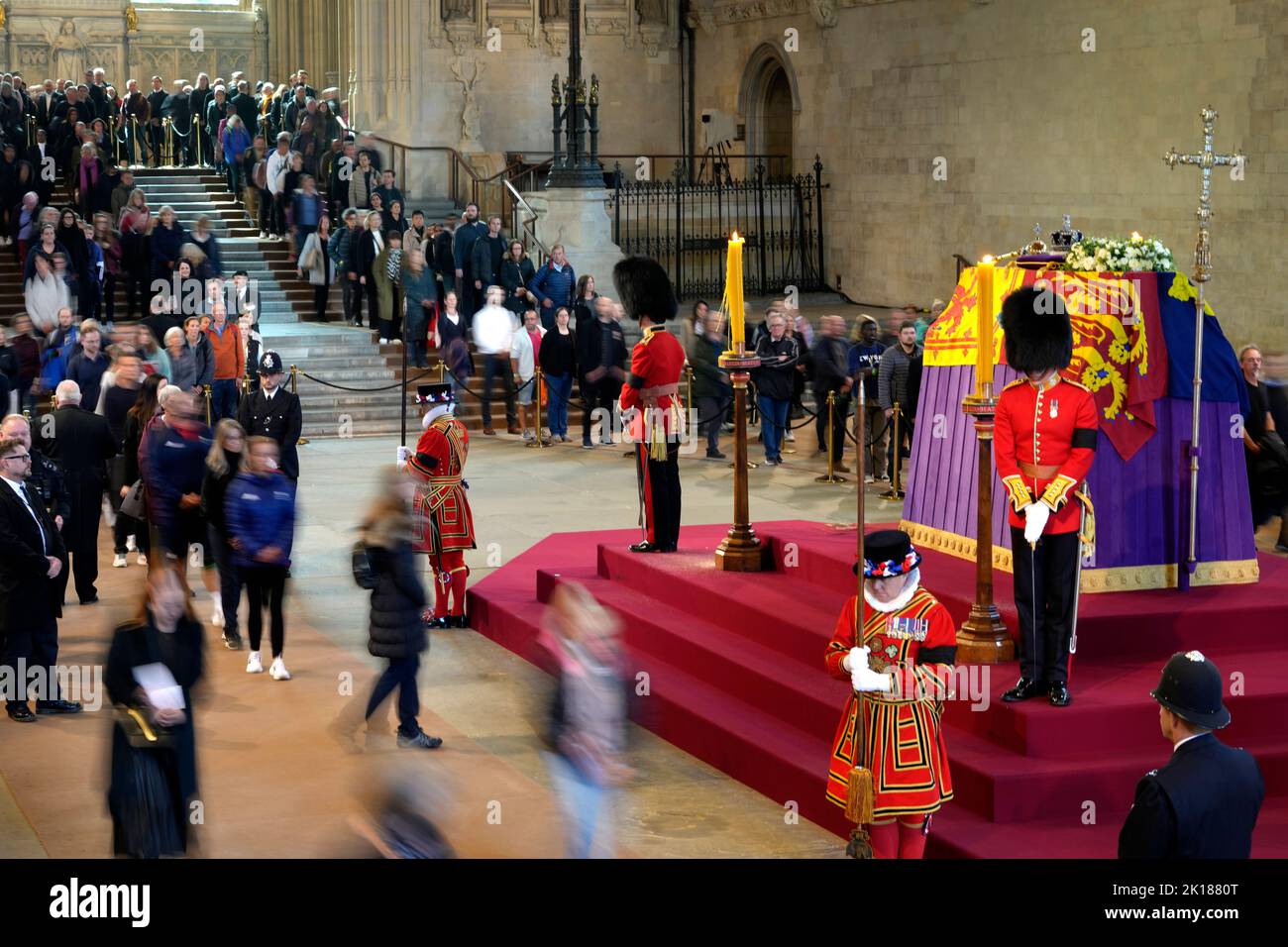 Members of the public file past the coffin of Queen Elizabeth II, draped in the Royal Standard with the Imperial State Crown and the Sovereign's orb and sceptre, lying in state on the catafalque in Westminster Hall, at the Palace of Westminster, London, ahead of her funeral on Monday. Picture date: Friday September 16, 2022. Stock Photo