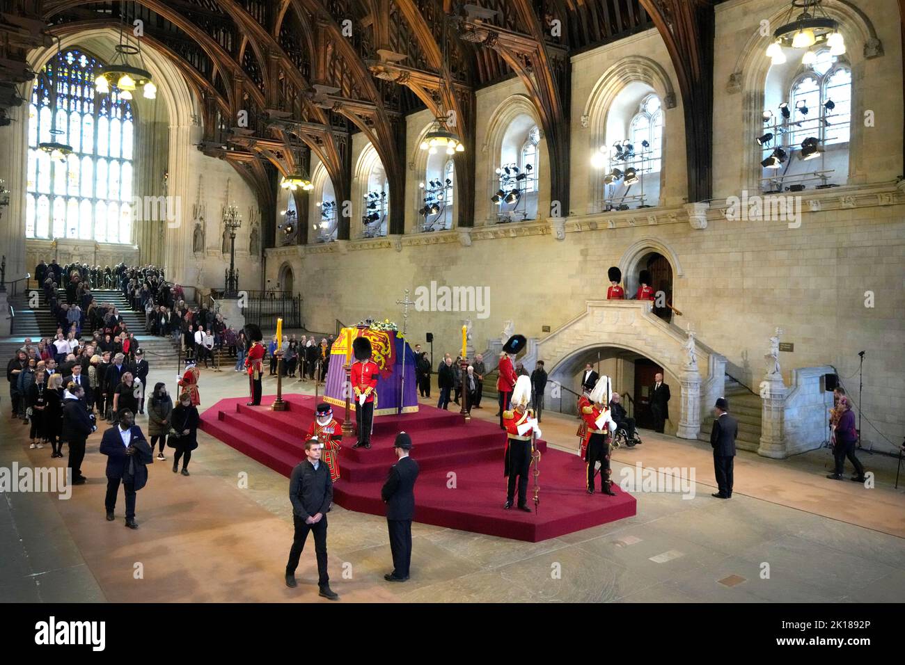 Members of the public file past the coffin of Queen Elizabeth II, draped in the Royal Standard with the Imperial State Crown and the Sovereign's orb and sceptre, lying in state on the catafalque in Westminster Hall, at the Palace of Westminster, London, ahead of her funeral on Monday. Picture date: Friday September 16, 2022. Stock Photo