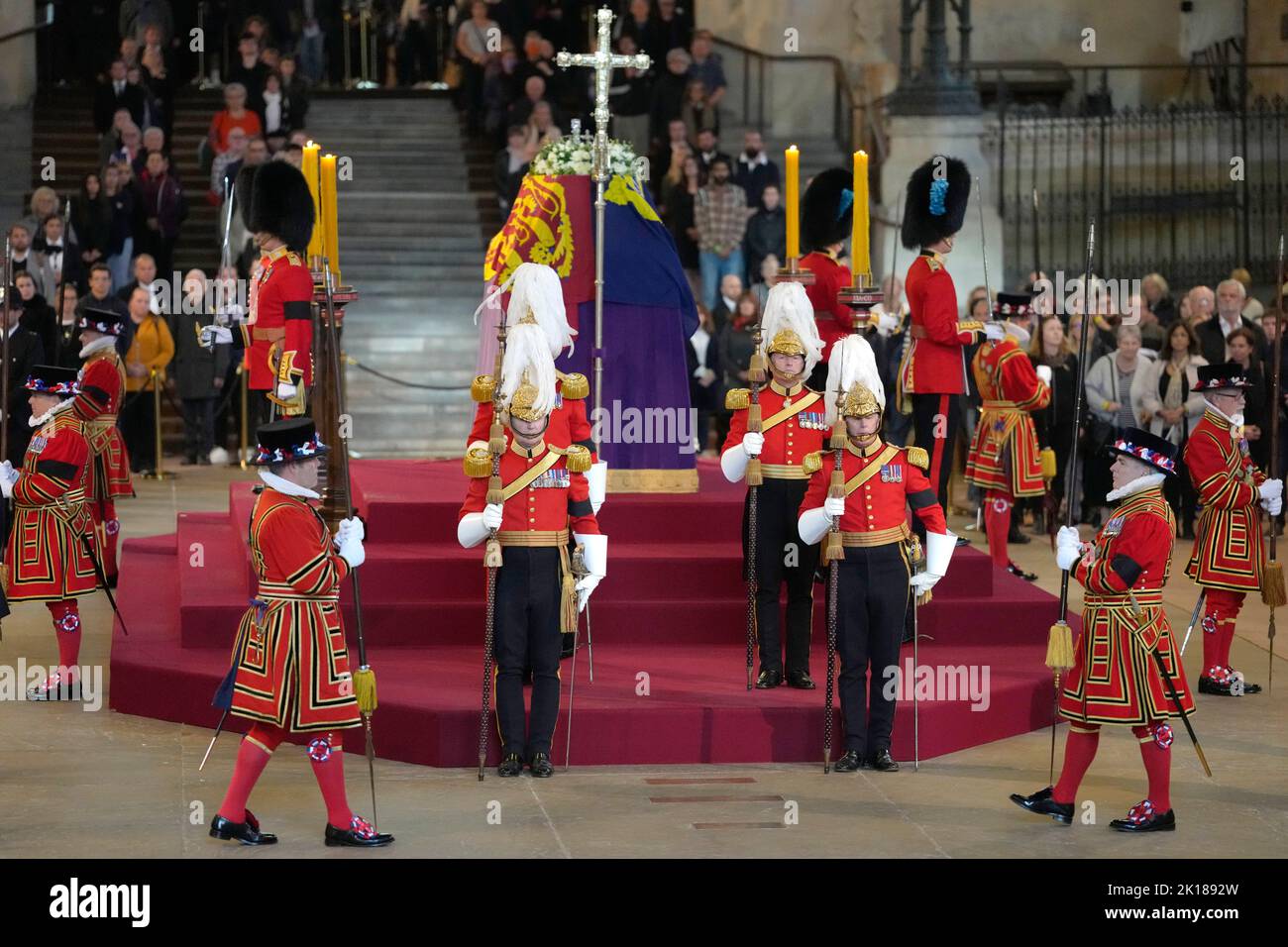 Guards are changed as members of the public file past the coffin of Queen Elizabeth II, draped in the Royal Standard with the Imperial State Crown and the Sovereign's orb and sceptre, lying in state on the catafalque in Westminster Hall, at the Palace of Westminster, London, ahead of her funeral on Monday. Picture date: Friday September 16, 2022. Stock Photo