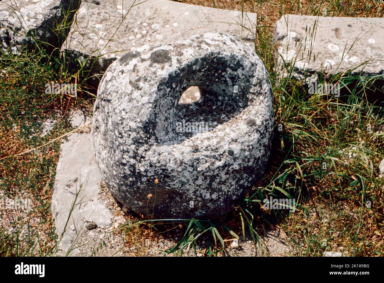 Stone weight in Roman Baths at Epidaurus - a small city (polis) in ancient Greece, on the Argolid Peninsula at the Saronic Gulf, best known for its ancient Greek sanctuary. March 1980. Archival scan from a slide. Stock Photo