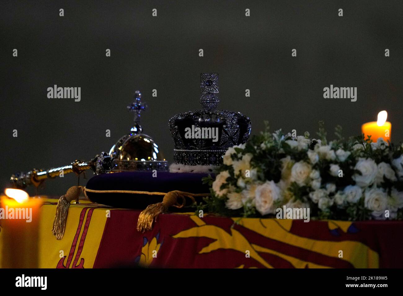 The coffin of Queen Elizabeth II, draped in the Royal Standard with the Imperial State Crown and the Sovereign's orb and sceptre, lying in state on the catafalque as members of the public file past in Westminster Hall, at the Palace of Westminster, London, ahead of her funeral on Monday. Picture date: Friday September 16, 2022. Stock Photo